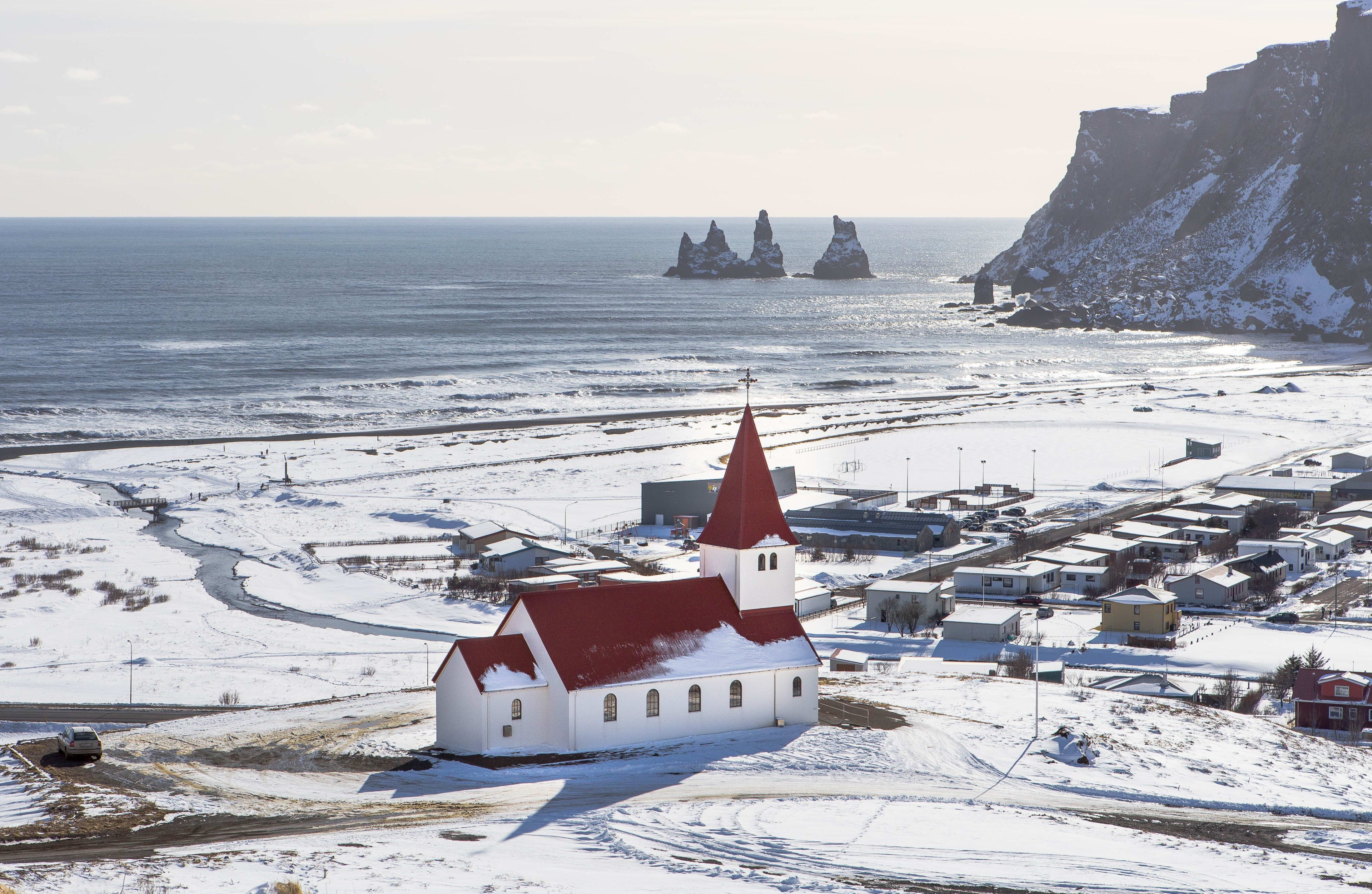 vik town and its red church in winter