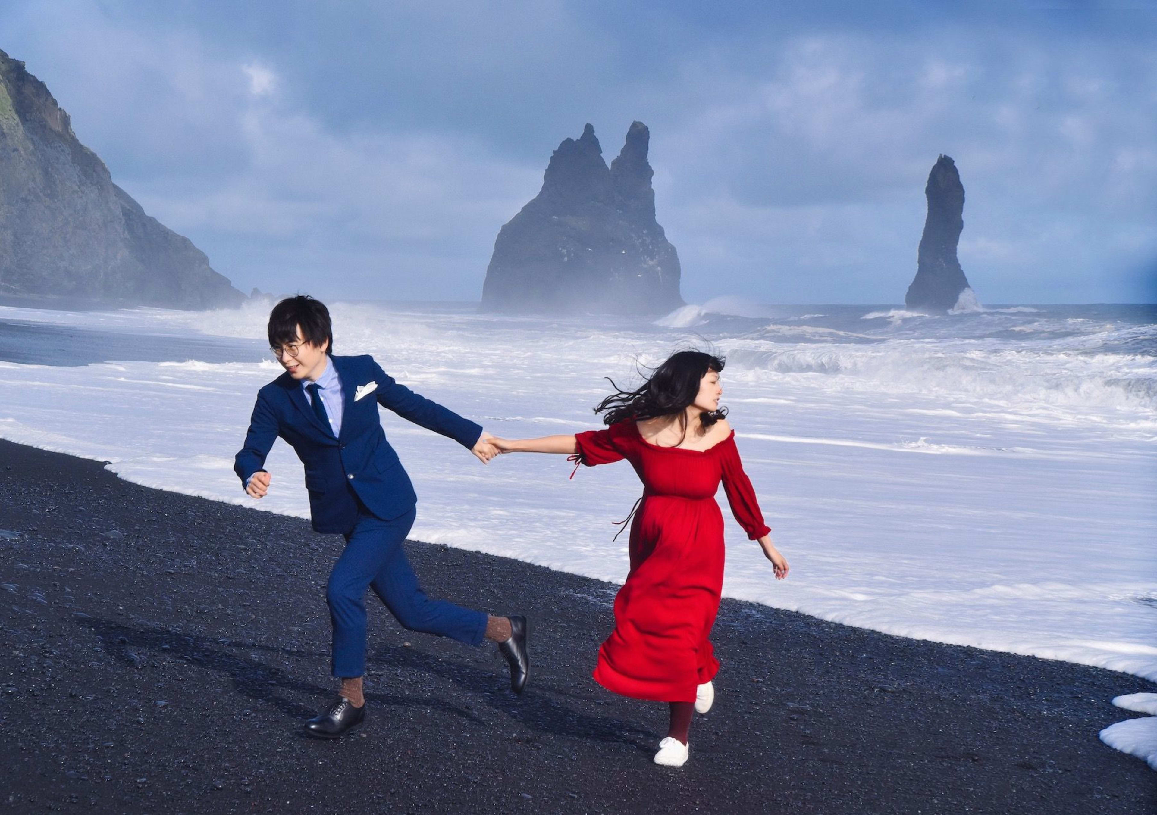 Couple Running on the Black Sand Beach