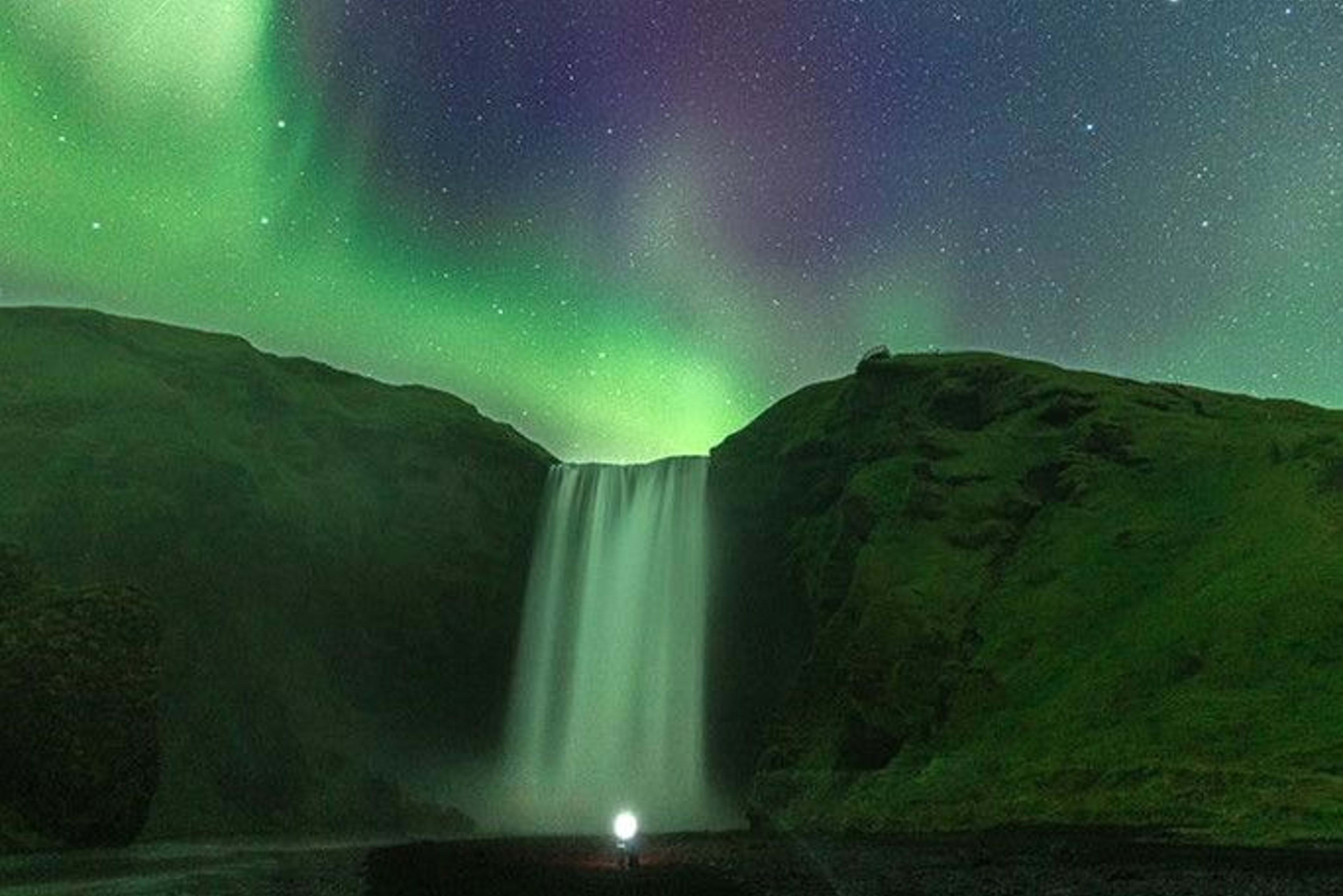 skogafoss with northern lights covered