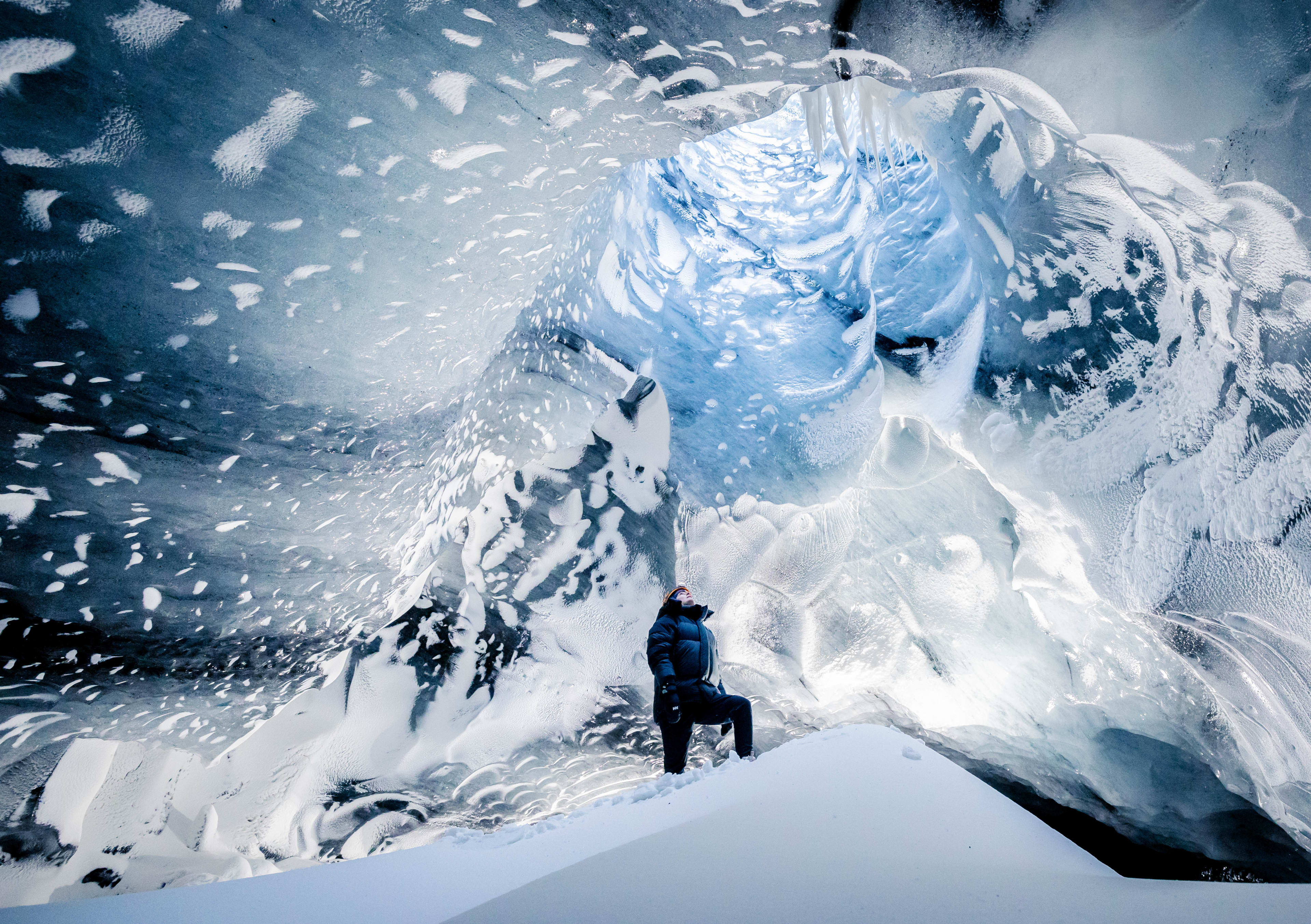 people in Myrdalsjokull ice cave of iceland