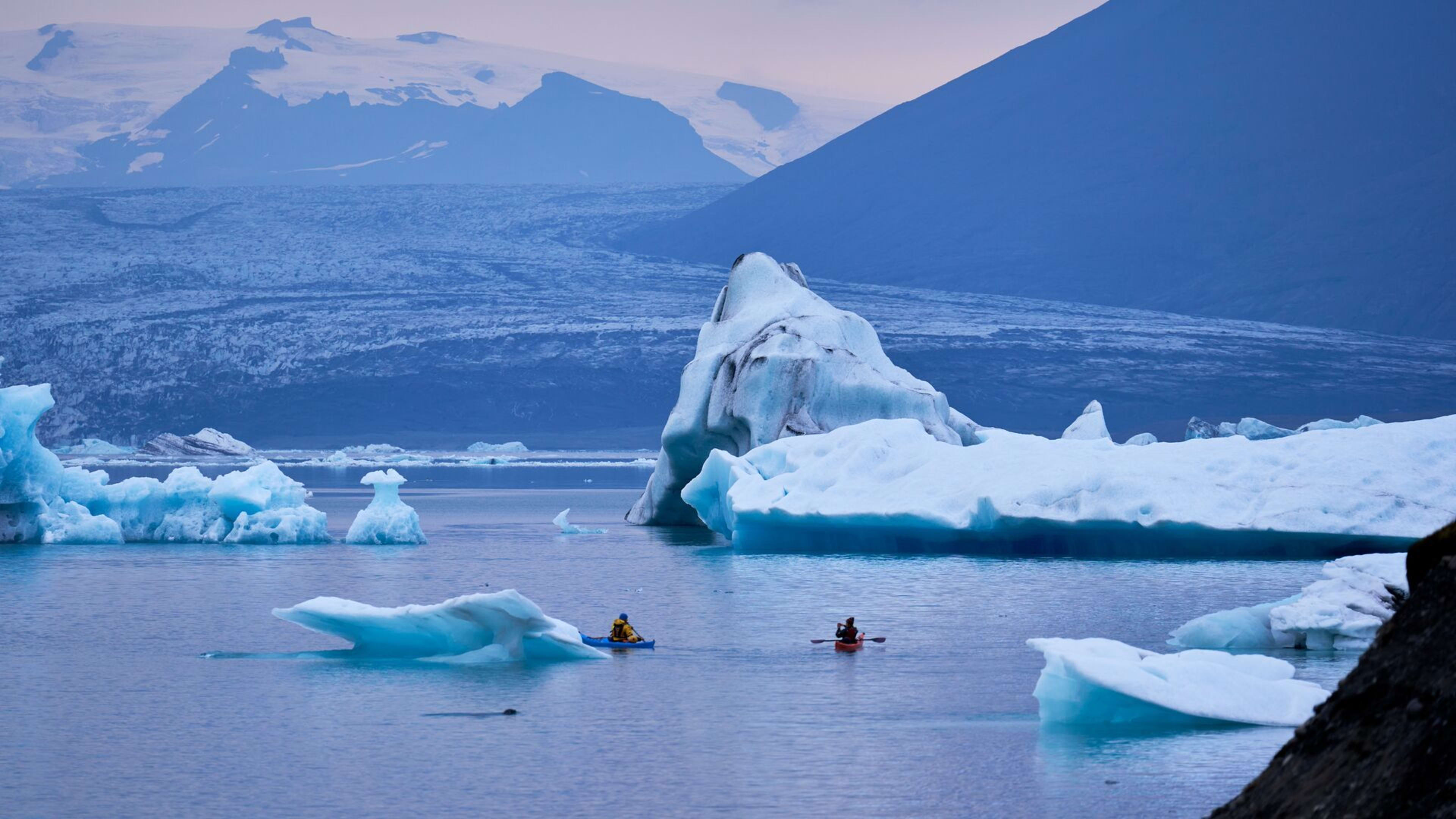 two people kayaking in ice lagoon