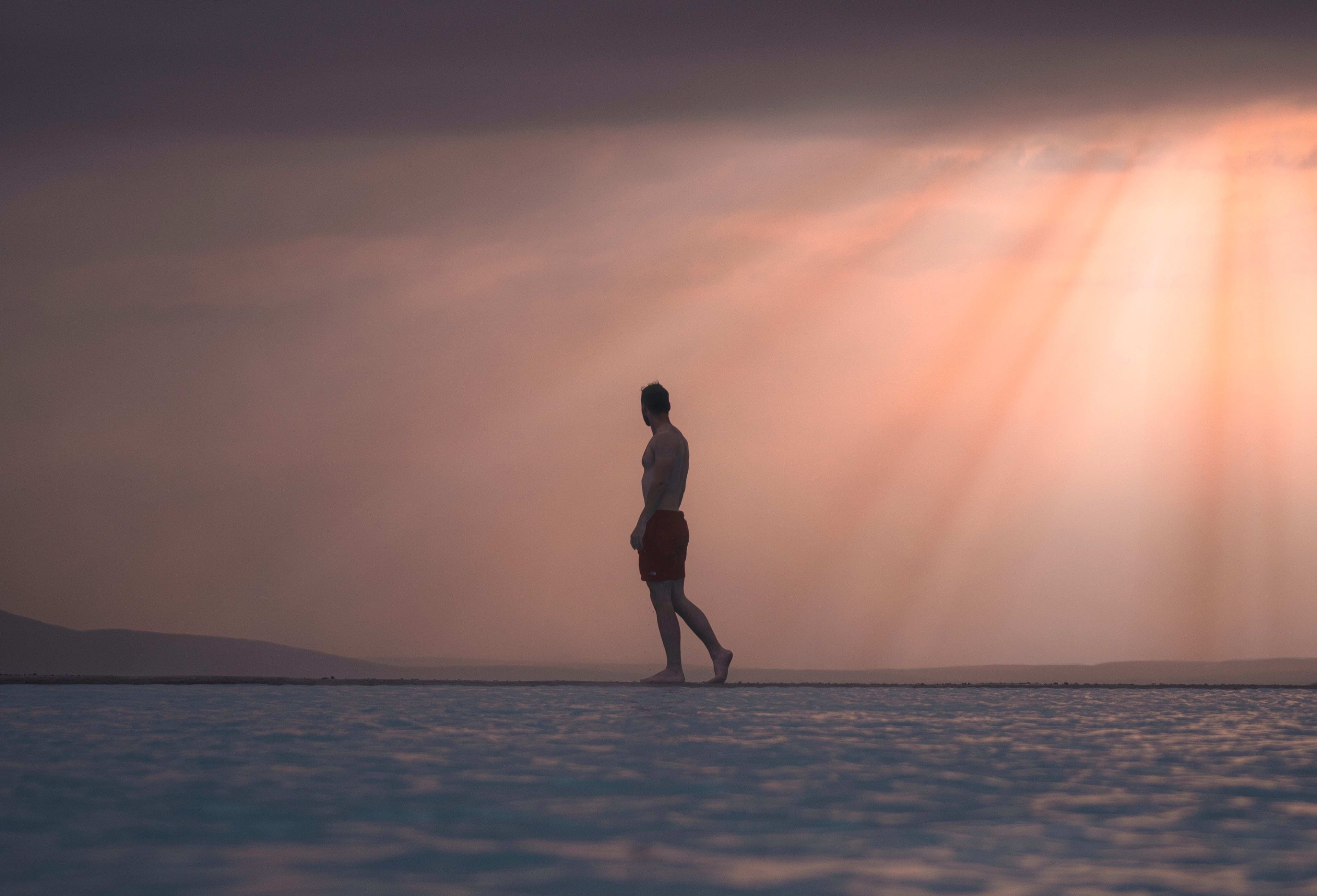 man at Myvatn Nature Baths under sunset