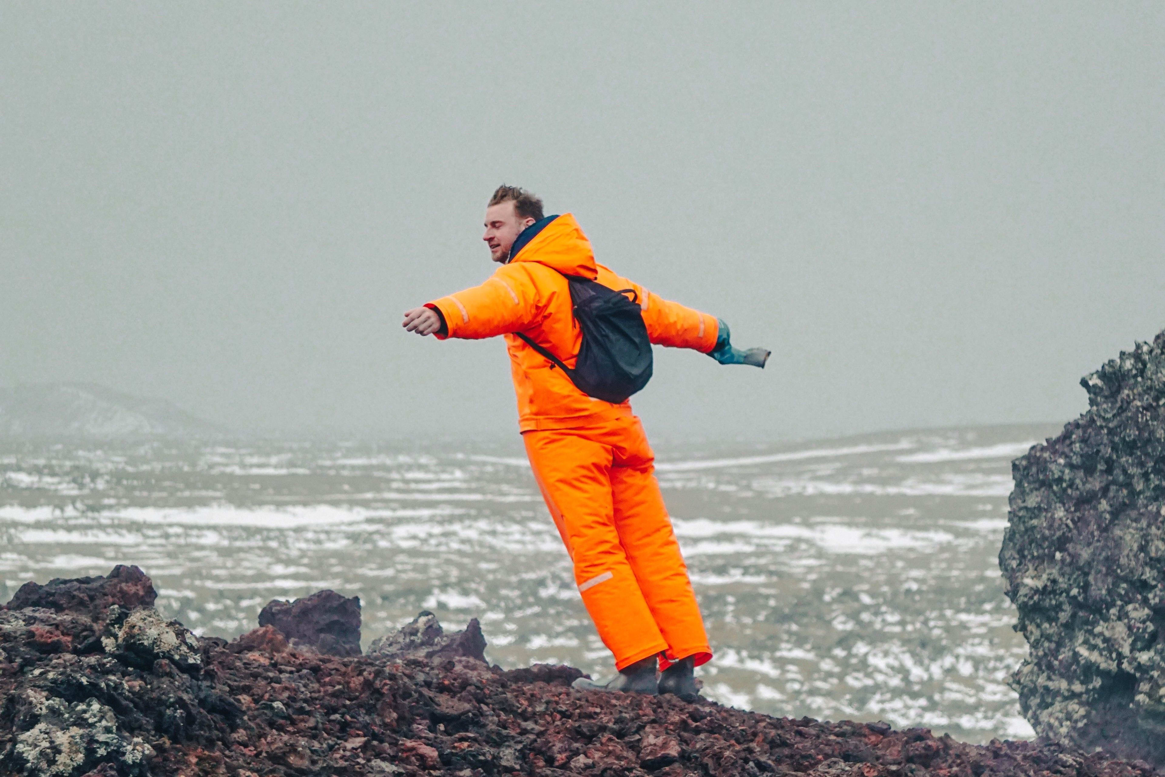 man resisting strong iceland winds