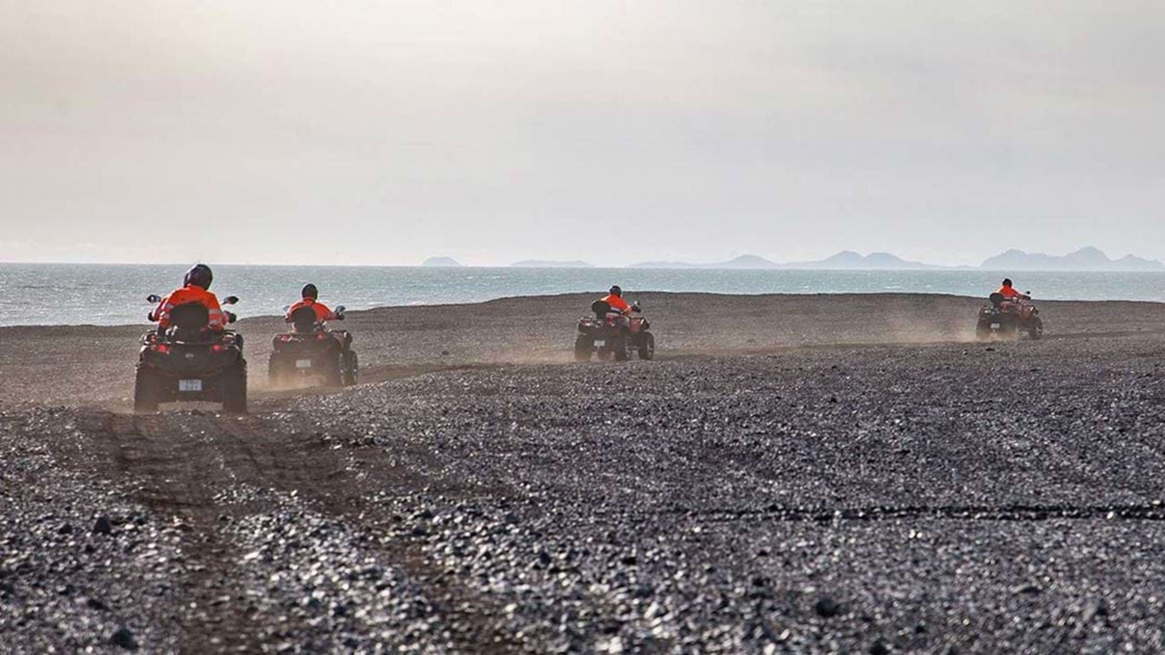 driving ATV on black sand beach in iceland