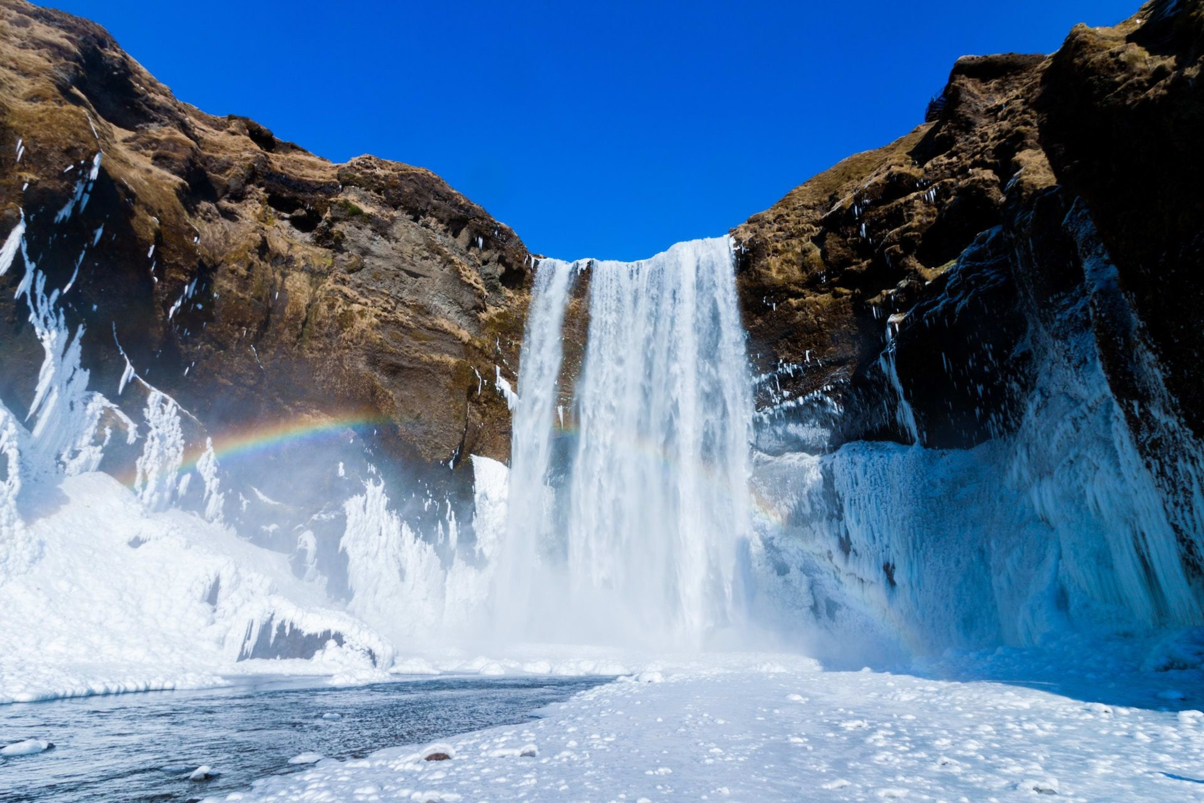 skogafoss with rainbow around