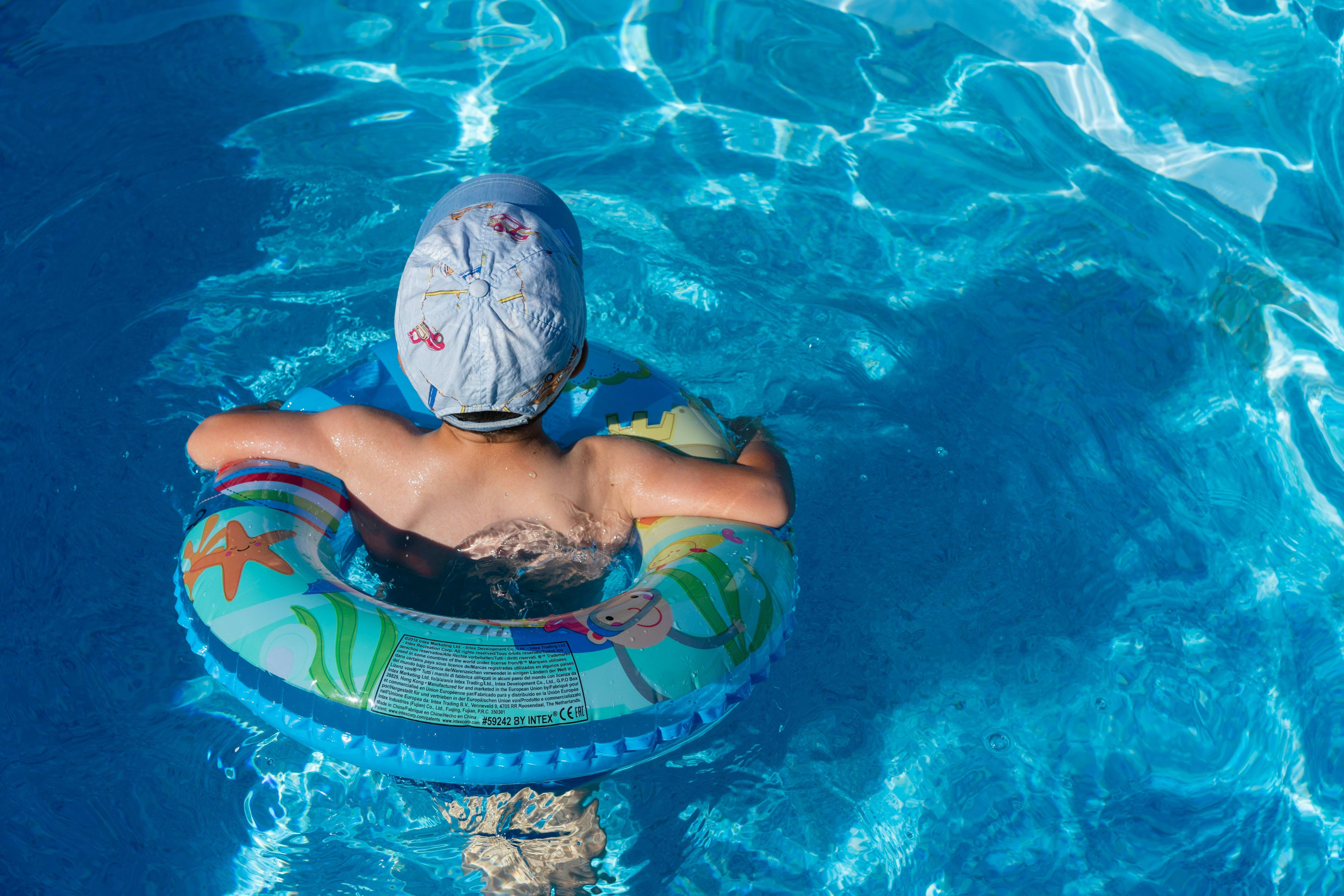 children swimming in pool