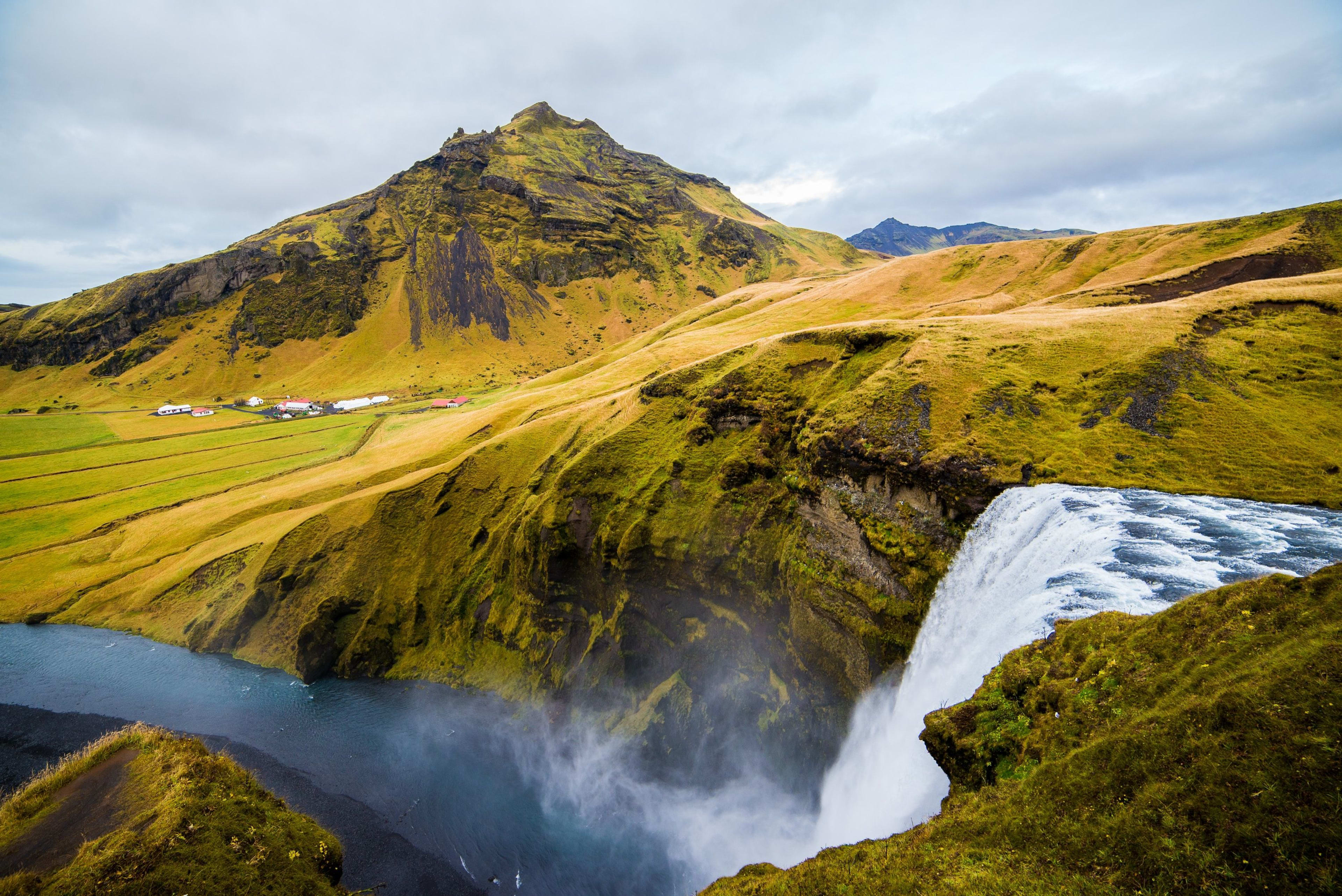 skogafoss with mountain and cliff from above 