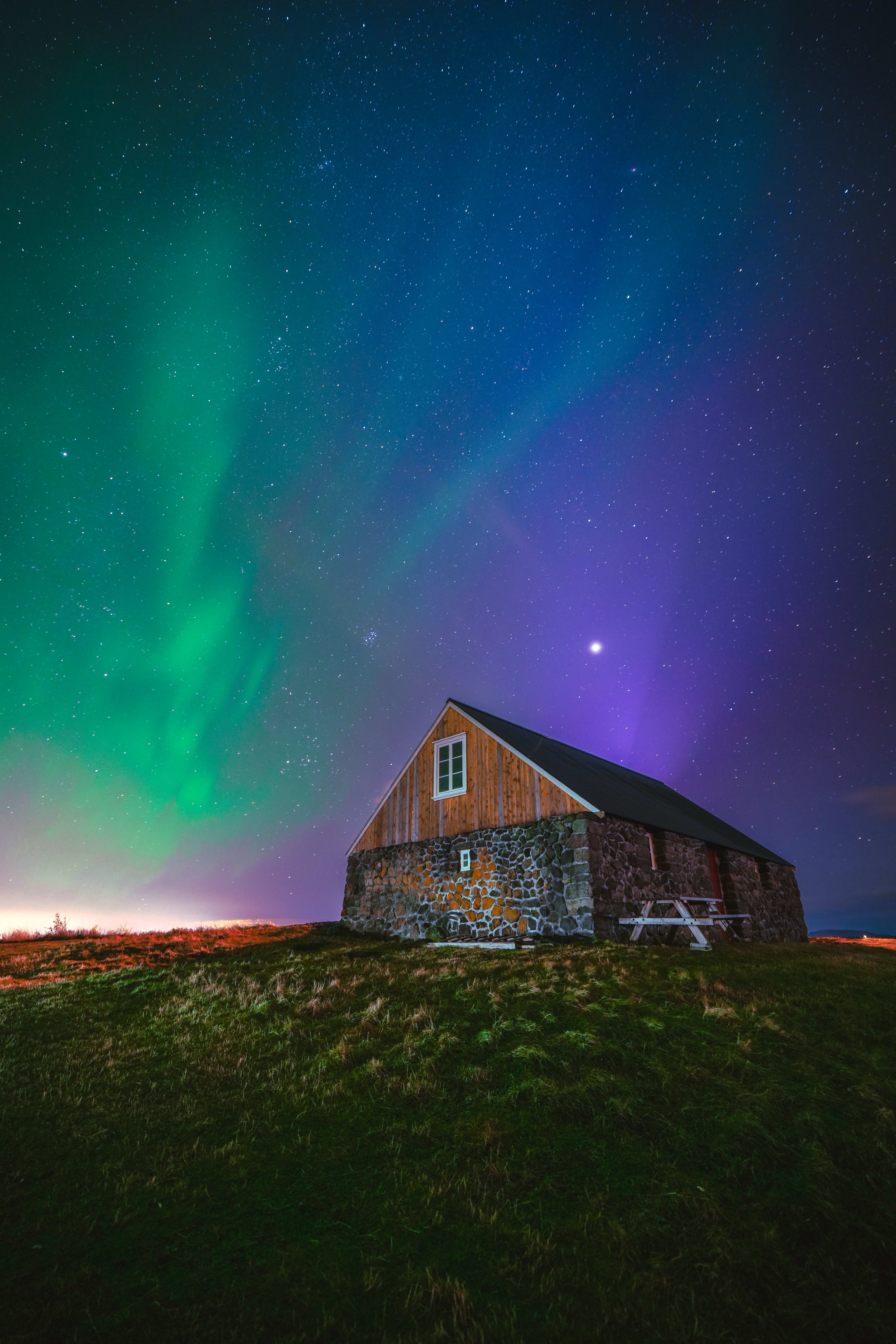 house in iceland with aurora borealis