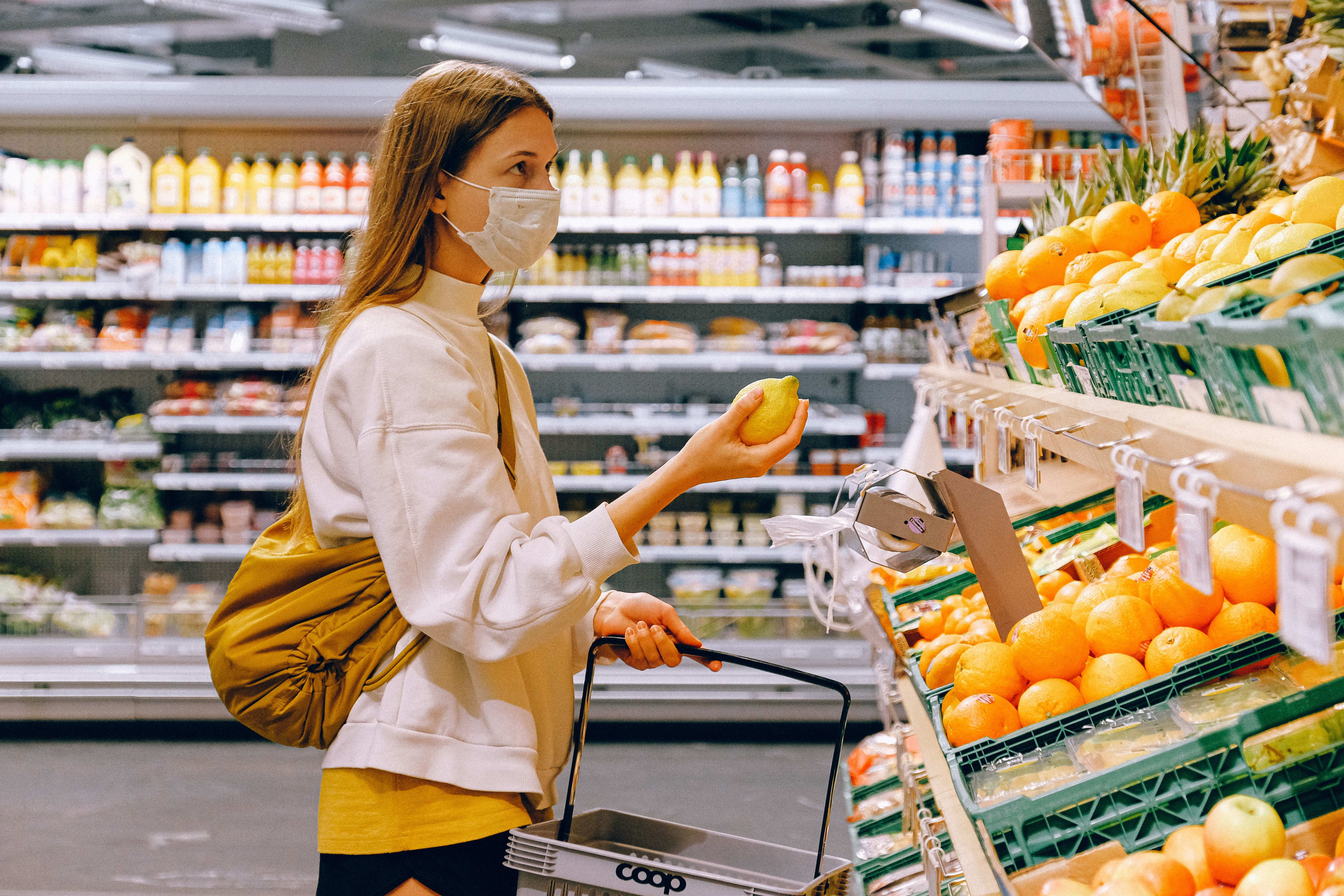 girl selecting fruit in the supermarket