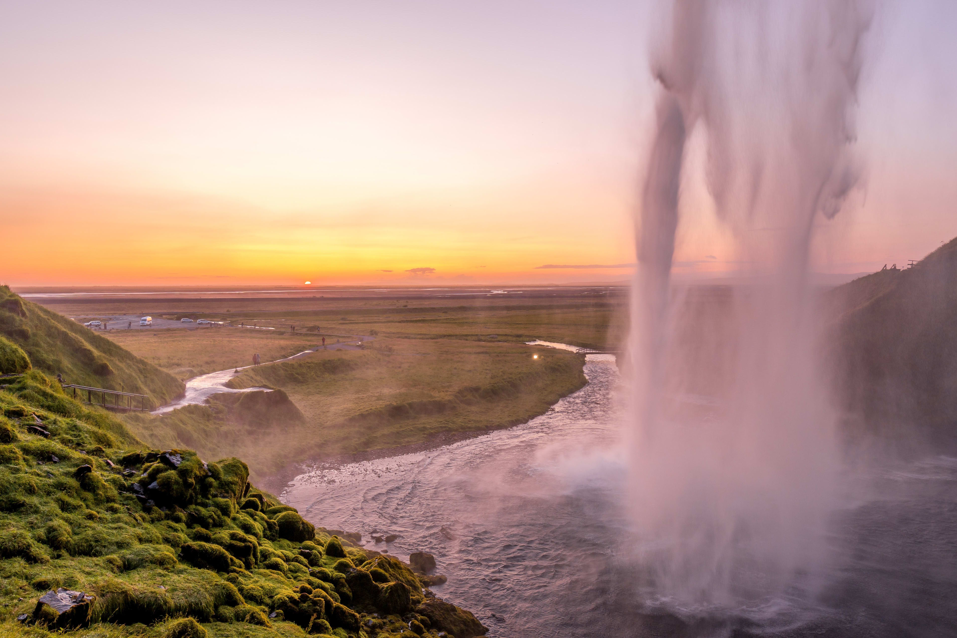 seljalandsfoss from behind with sunset