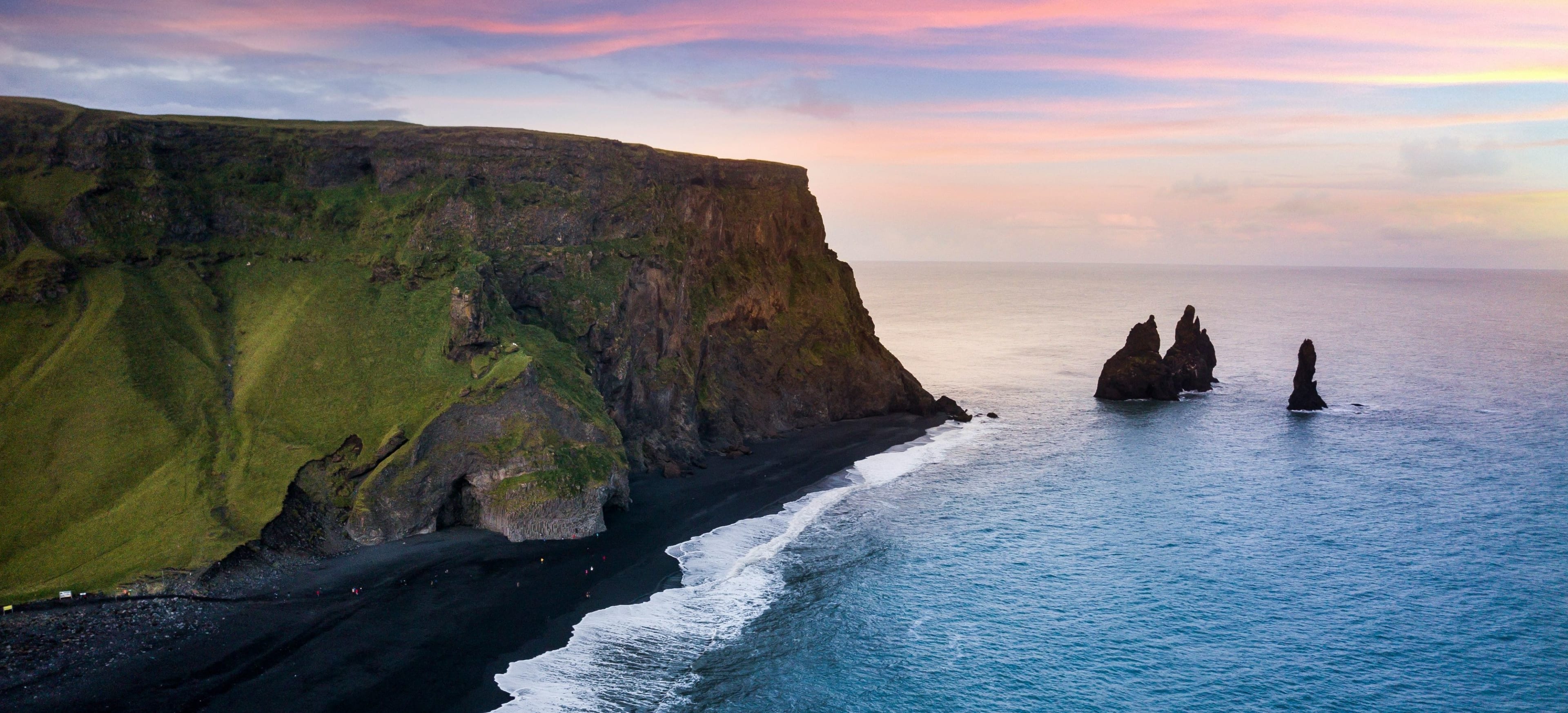 reynisfjara black sand beach with sea under dreamy sky
