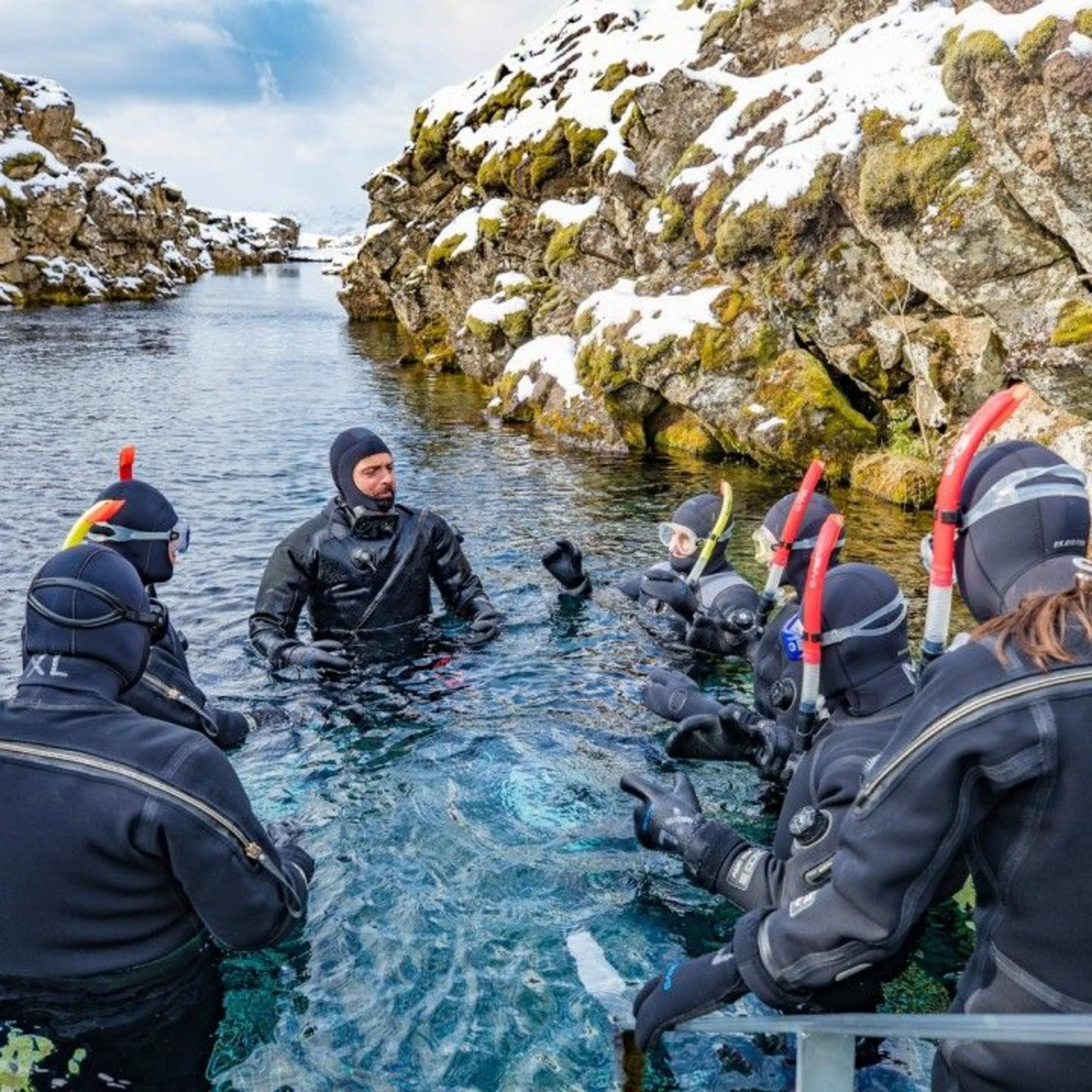 snorkeling guide with participants in silfra